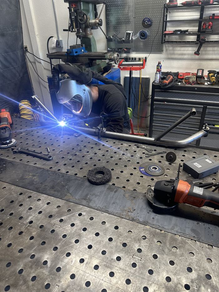Welding a bent tube frame on the shop's fixture table